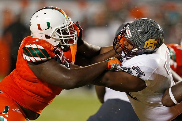 Kendrick Norton, left, as a member of the Miami Hurricanes