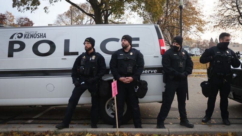 Police keep watch as demonstrators gather outside of the Kenosha County Courthouse as the jury deliberates in the trial of Kyle Rittenhouse on November 16, 2021 in Kenosha, Wisconsin. 