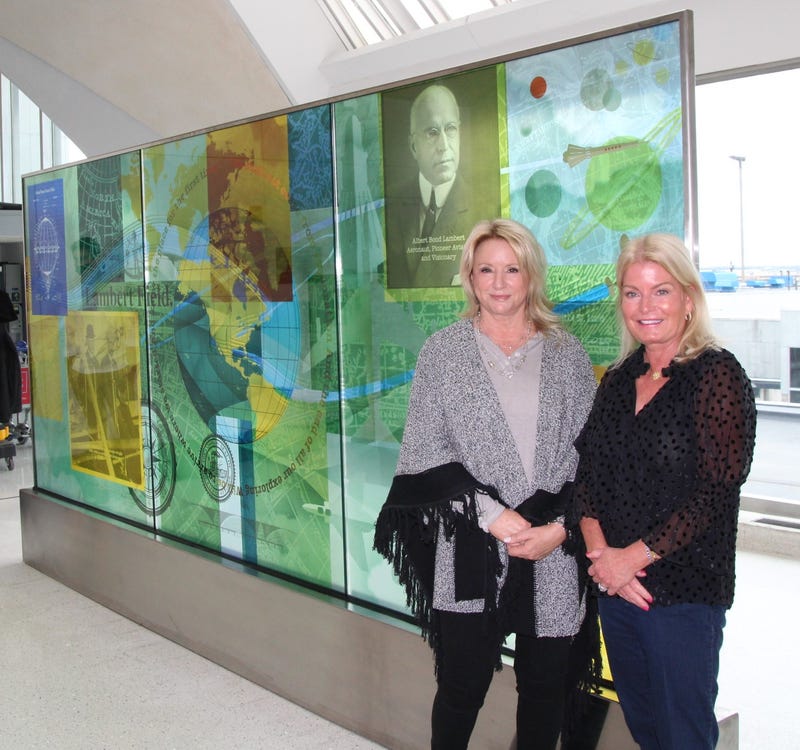Major Lambert's great-granddaughters Kim Lambert and Lea Bender in front of the mural dedicated to the airport's founder