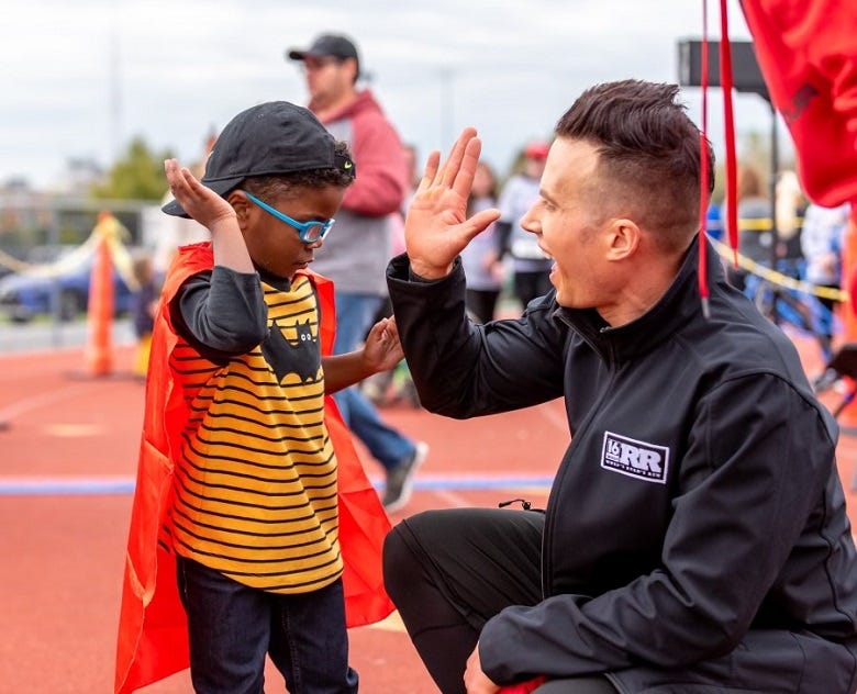 WNEP's Ryan Leckey high fiving a young viewer