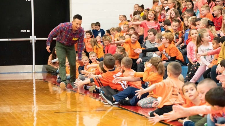 Ryan Leckey with kids in a gym