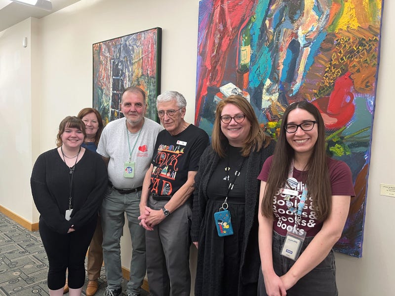 Kip and Bob pose for a photo with other members of the Cherry Hill Library staff.