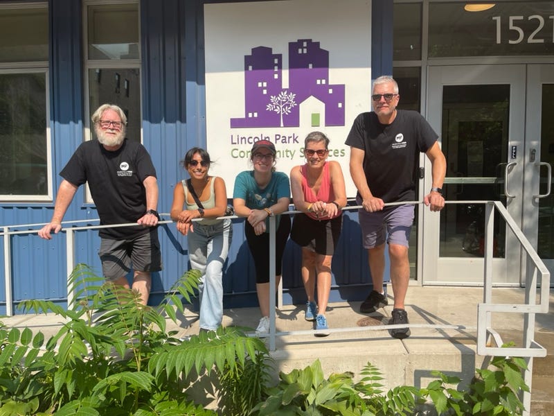 Musically Fed volunteers pose in front of Lincoln Park Community Services, which helps individuals facing homelessness and poverty secure stable housing. The group is one of several that Musically Fed will be distributing excess food from Lollapalooza to.