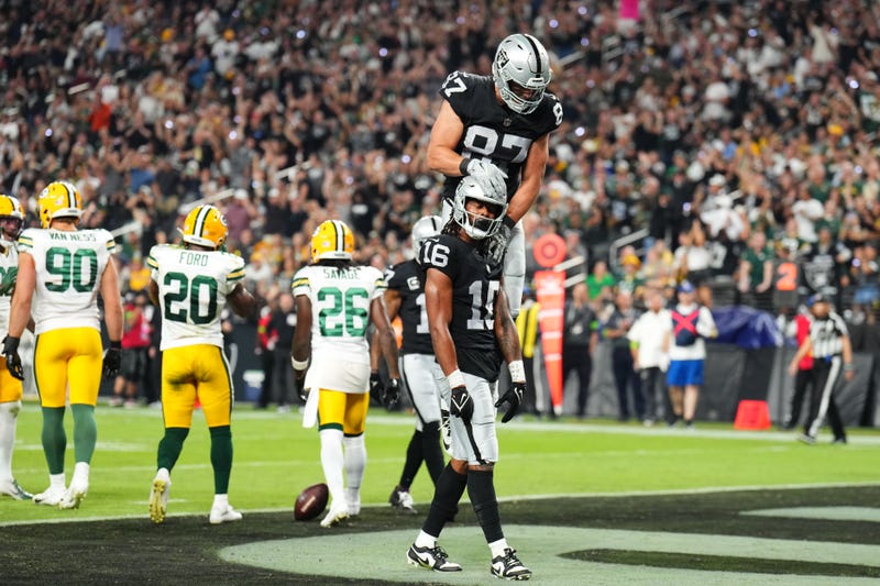 Jakobi Meyers #16 of the Las Vegas Raiders celebrates his touchdown catch with Michael Mayer #87 during the second quarter against the Green Bay Packers at Allegiant Stadium