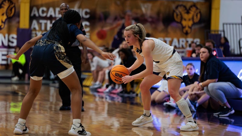Leah Johnson faces off against a defender on the basketball court.