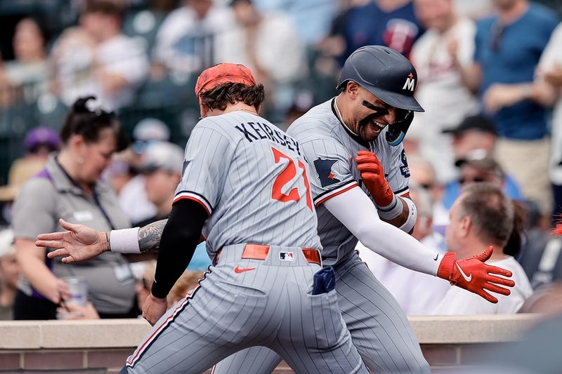 Minnesota Twins third baseman Royce Lewis (23) celebrates his solo home run with outfielder DaShawn Keirsey Jr. (21) in the eighth inning against the Colorado Rockies at Coors Field. 