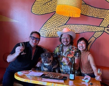 Liam Mayclem with Chef David Murphy, Kayla Abe and Beef the dog at Shuggie’s.