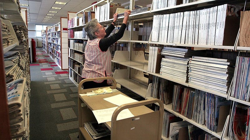 : Employee Kathleen Barnes restocks magazine and newspaper shelves at the Des Plaines Public Library November 14, 2002 in Des Plaines, Illinois. 