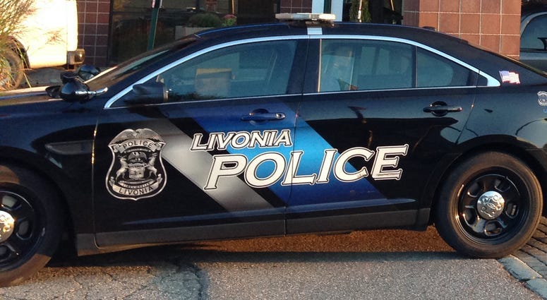 A Detroit man accused of robbing a Livonia bank of $2,000 at gunpoint was apprehended by police with his young son in his getaway car, federal agents say.