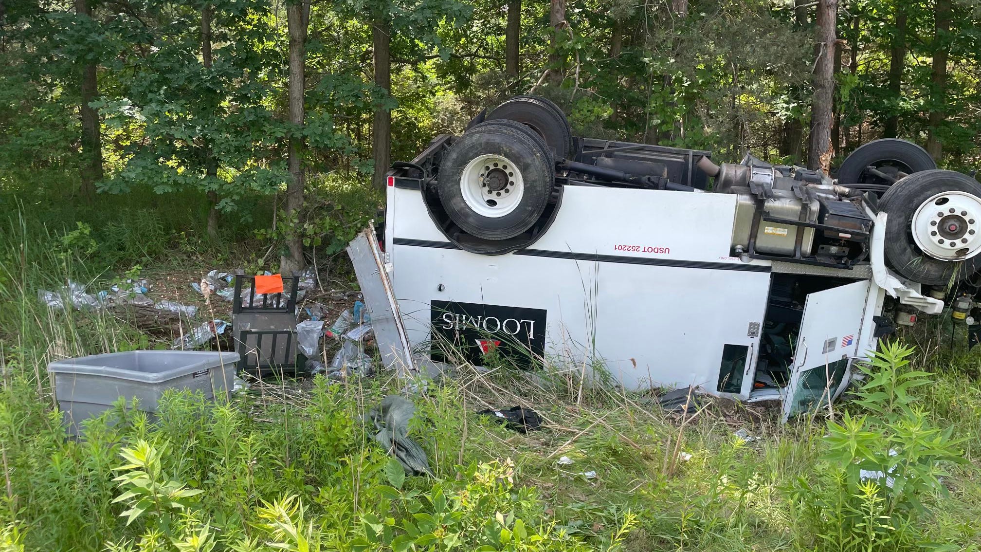 Money thrown from Loomis armored truck after crashing in traffic backup near Lansing, overturning in ditch