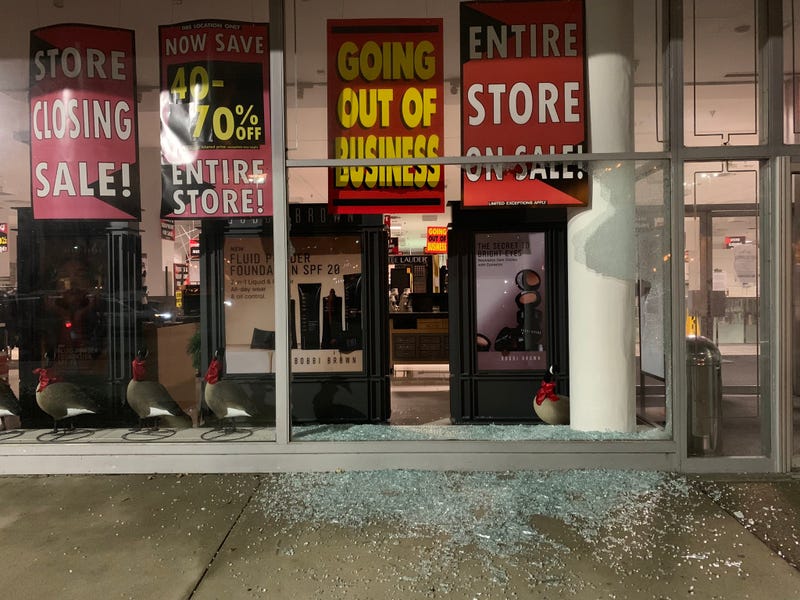 Broken glass remains after looters broke into the Lord & Taylor on City Avenue on Wednesday night.