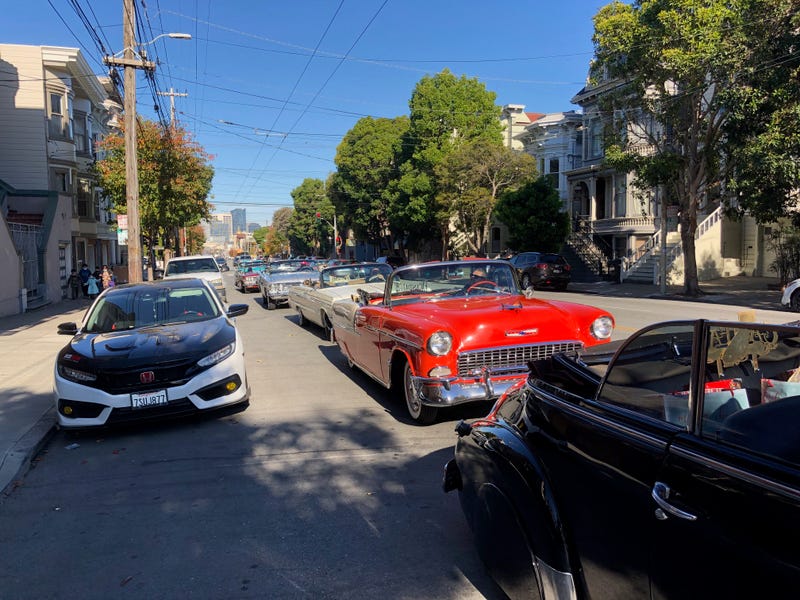 Lowriders line the streets to deliver toys to families in need.
