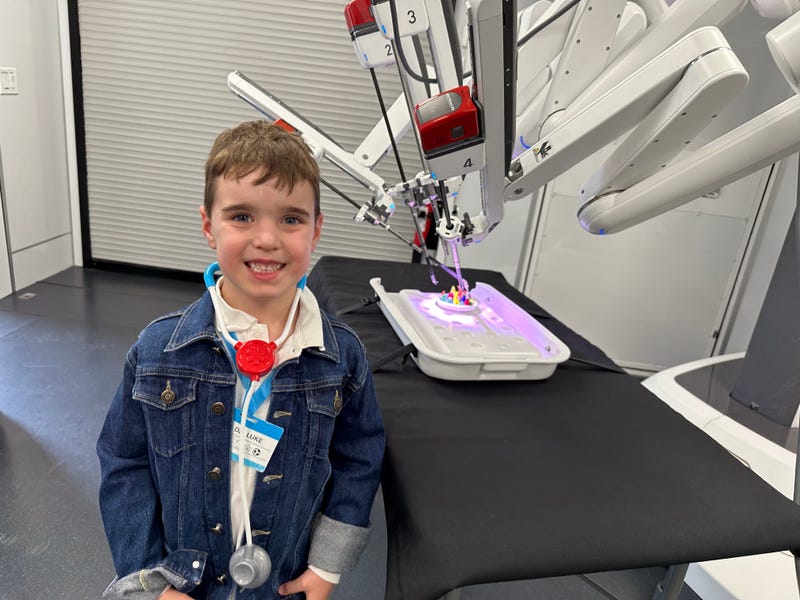 Luke Bucciarelli, 6, plays with a surgical robot.