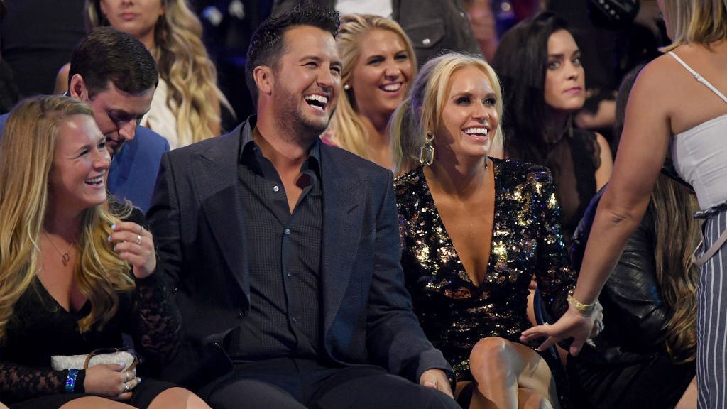 Luke Bryan’s Wife Shares Shirtless Photo of Him Hugging Their Dog: “Arms Be Poppin”