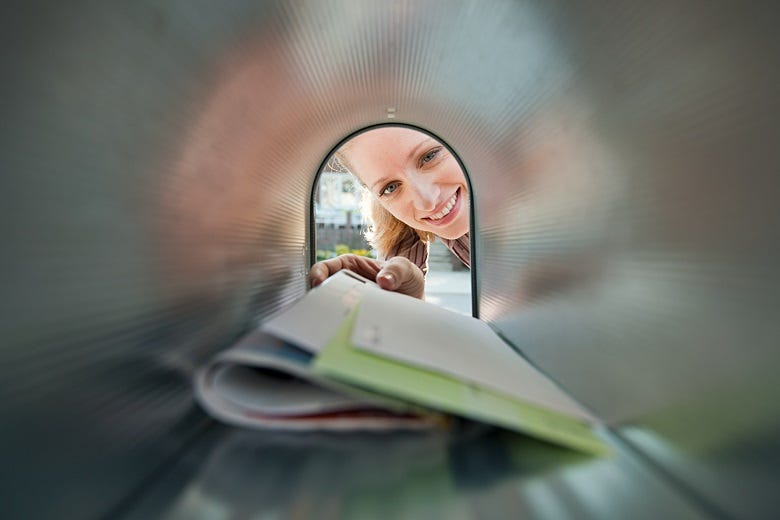 Woman looking into mailbox