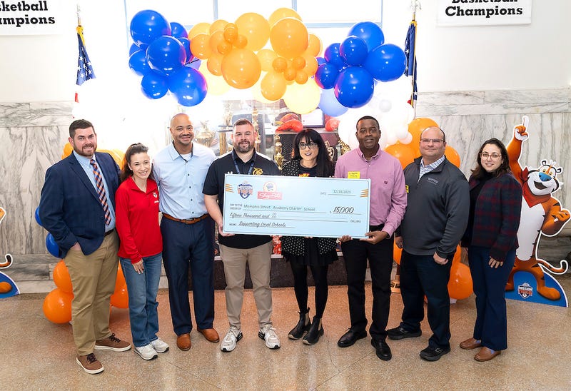 Leaders from the Memphis Street Academy Charter School pose with a check for $15,000.