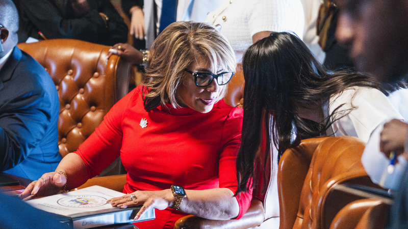 Councilwoman Quetcy Lozada speaks to a staffer on Thursday, May 1.