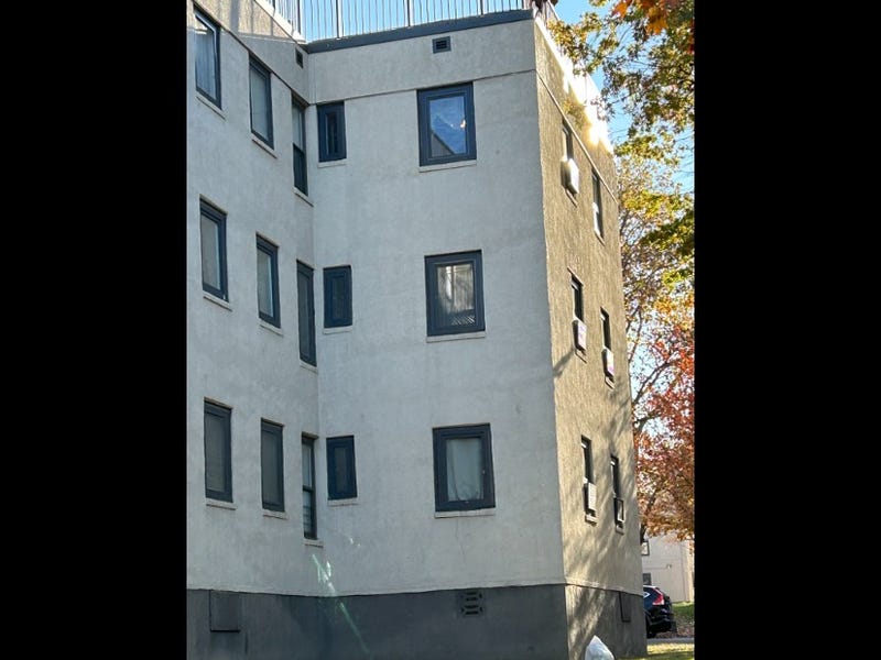 A 64-year-old woman either jumped or was pushed from her third-story Astoria apartment window after being threatened by her knife-wielding son on Friday night.