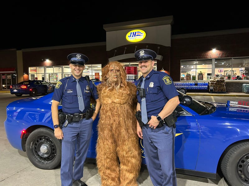 Michigan State Police troopers with man in Bigfoot costume