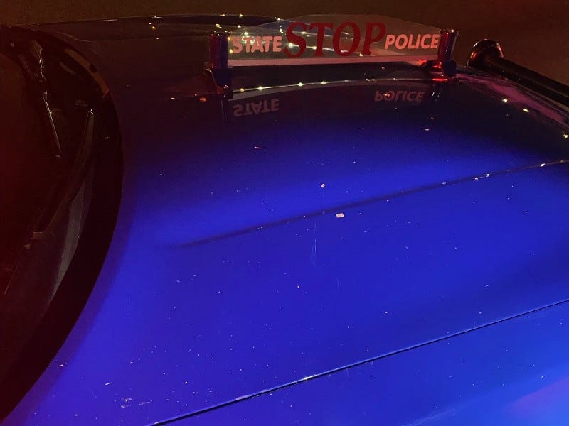 MSP patrol car hit by bottle