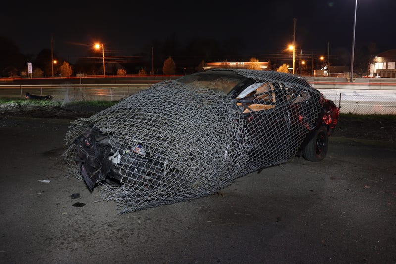 Car wrapped in fence