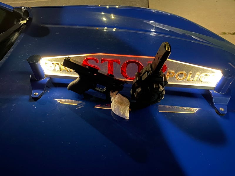 Stolen gun and bag of pills on MSP car