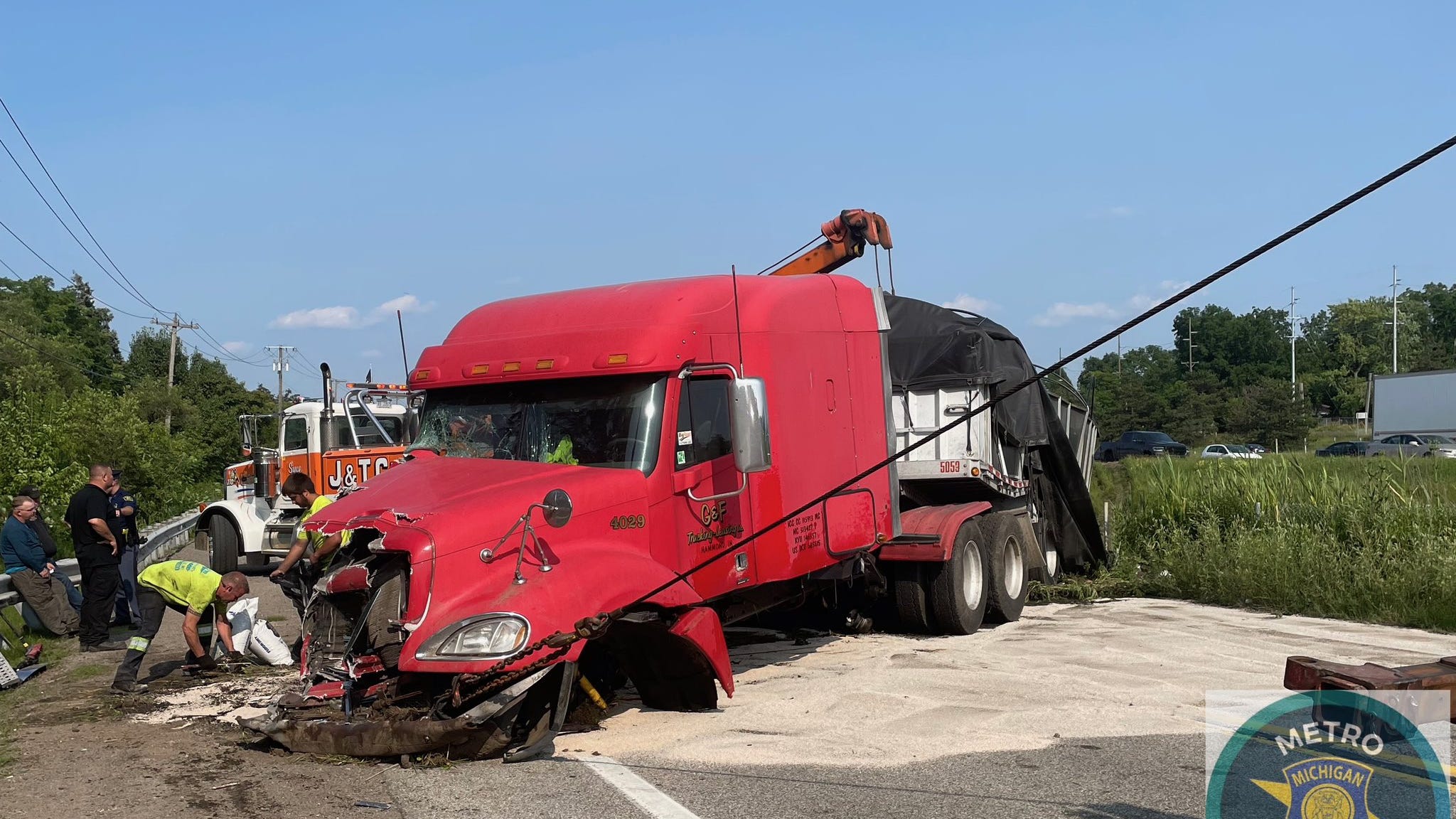 Semi driver ticketed after rear-ending cars on I-94, crashing through fence, slamming into illegally parked tow truck