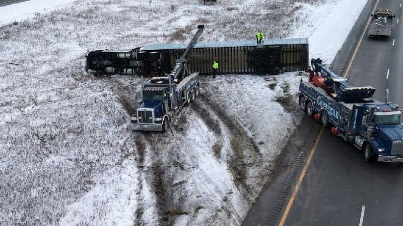 Driver cited for careless driving after semi-truck carrying mail overturns on I-96, causing 2-hour closure [PHOTOS]