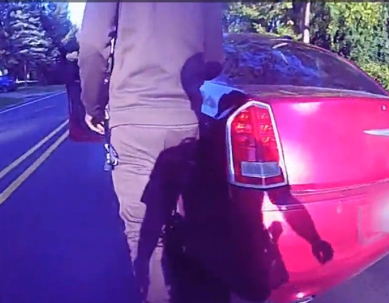 Body camera footage shows uncooperative suspect walking back to car before dragging Michigan State Police trooper