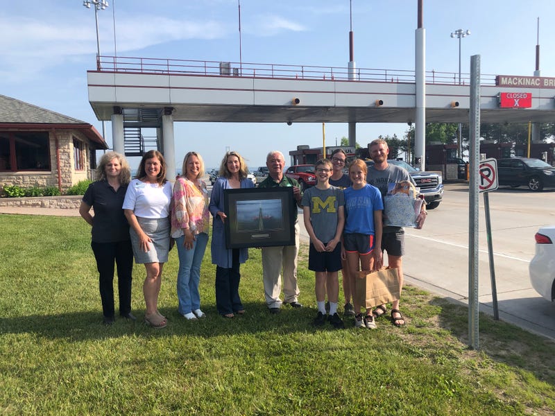 The Dalman family of Tawas City, far right, received a local gift basket and a framed print of the Mackinac Bridge after they drove the 200 millionth vehicle across the bridge. Left to right: MBA Chief Bridge Engineer Julie Neph; Mackinaw City Chamber of Commerce Executive Director Amy Millard; St. Ignace Visitors Bureau Executive Director Lora Brown; MBA Member Caroline Cheeseman; MBA Chairman Patrick “Shorty” Gleason; Seth Dalman; Anna Dalman; Teresa Dalman; and Kurt Dalman.