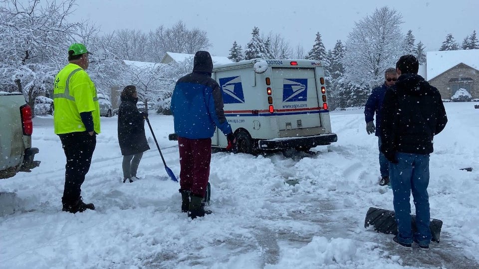 'These people are out doing their jobs': Metro Detroit neighbors step up to help free mail truck driver stuck in the snow