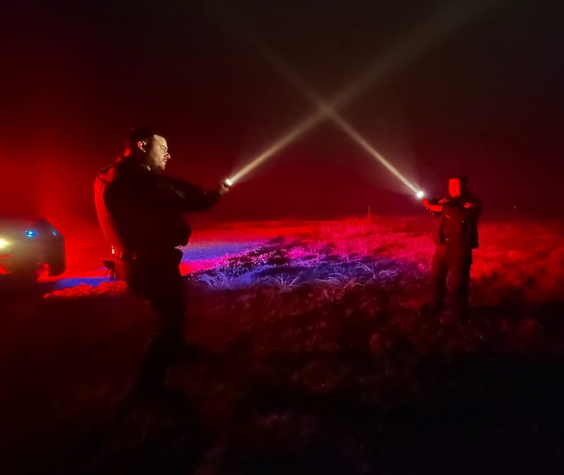 Mansfield police officers take advantage of the fog and use their flashlights as light sabers.