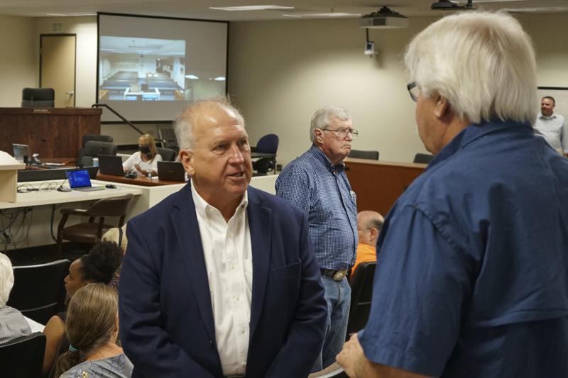 Mark Kampf speaks to a supporter at the Nye County Commission meeting on July 19, 2022, in Pahrump, Nev. County Commissioners voted to appoint Kampf to replace a longtime election official who resigned over the county's plan to transition to counting ballots by hand, without electronic voting machines.