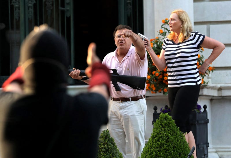 Mark and Patricia McCloskey on porch w Guns