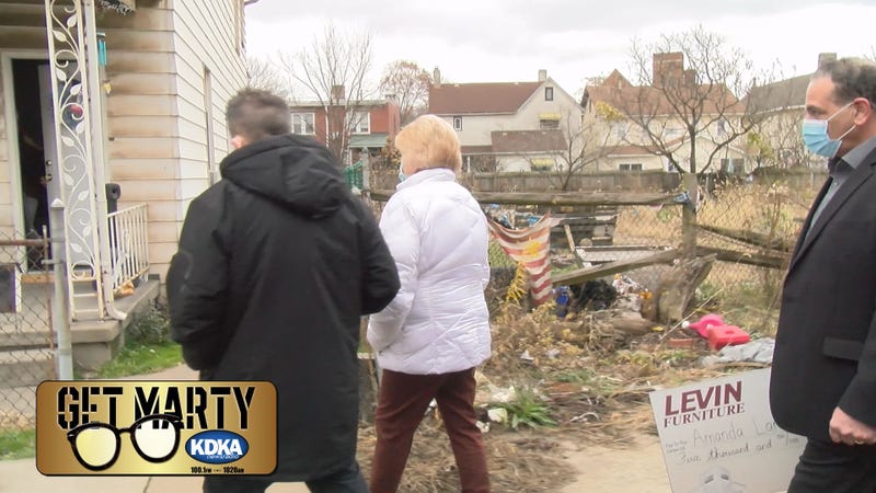Marty Griffin, "Aunt Tammy", and Ken Coury from Levin Furniture get ready to surprise Amanda