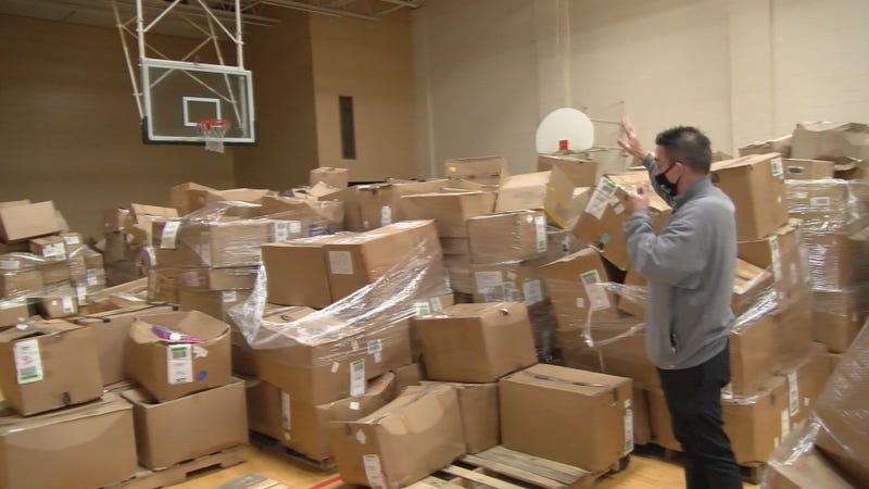 Marty stands among piles of donated boxes