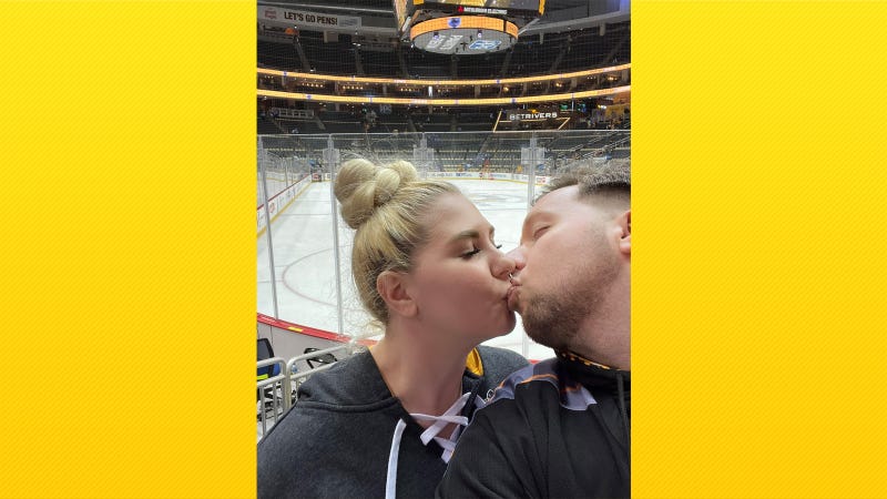 Matt McHugh and his girlfriend kiss at Penguins game