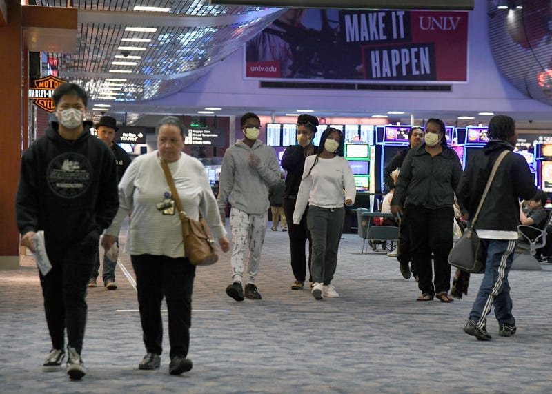 Travelers walk through the concourse at McCarran International Airport in Las Vegas