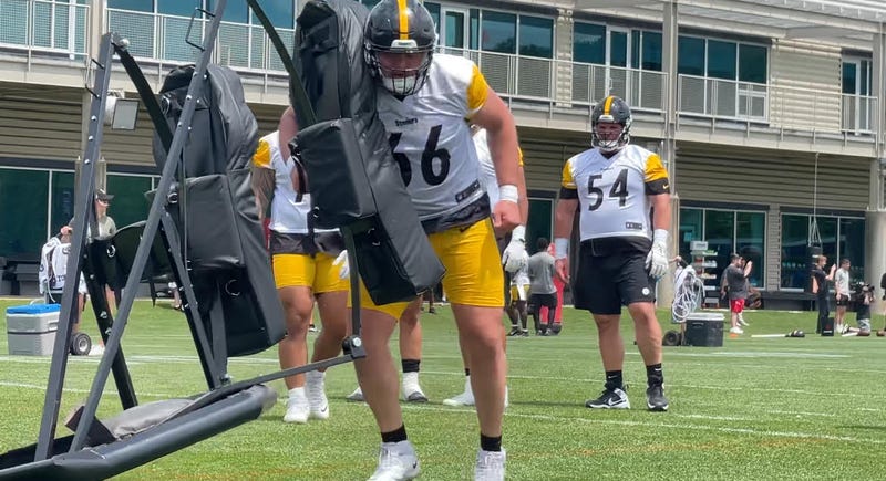 Mason McCormick lifting a sled in practice