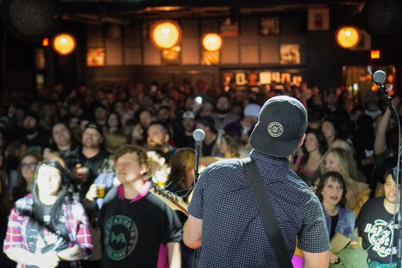 pike playing guitar to a crowd