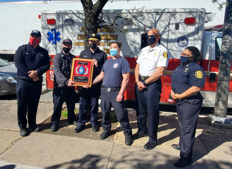 Philadelphia Fire Department officials along with members of the Medic 8 unit (left to right: Fire Commissioner Adam Thiel, EMT Michael Lasker, Paramedic Deputy Chief Eric Crouch, Paramedic James Lee, Deputy Commissioner Craig Murphy and Assistant Deputy Commissioner Crystal Yates) with a plaque naming them "America's Busiest Medic Unit."