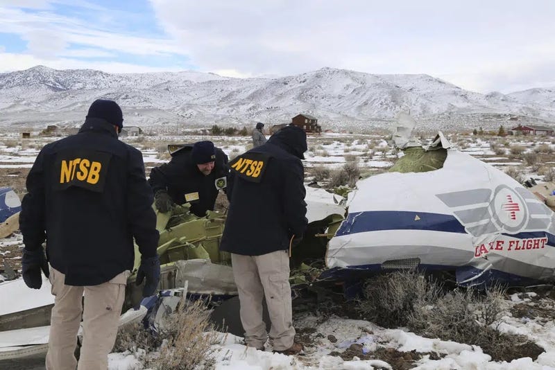 This photo provided by The National Transportation Safety Board shows NTSB investigators on Sunday, Feb. 26, 2023, at the crash site in Dayton, Nev., documenting the wreckage of a Pilatus PC-12 airplane a medical air transport flight operated by Guardian Flight that crashed on Friday, Feb. 24
