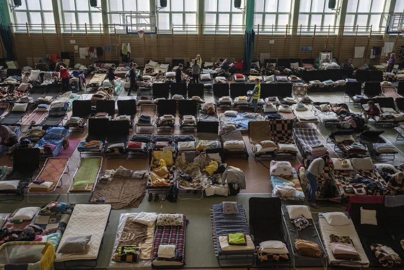 People who fled Ukraine rest in an indoor sports stadium, being used as a refugee center, in the village of Medyka, Poland