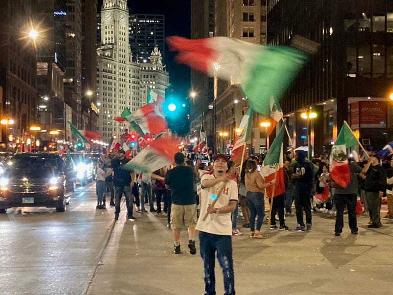 Man with Mexican flag in intersection