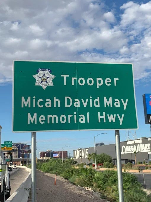 A sign shows that a portion of I-15 has been dedicated to fallen NHP Trooper Micah May
