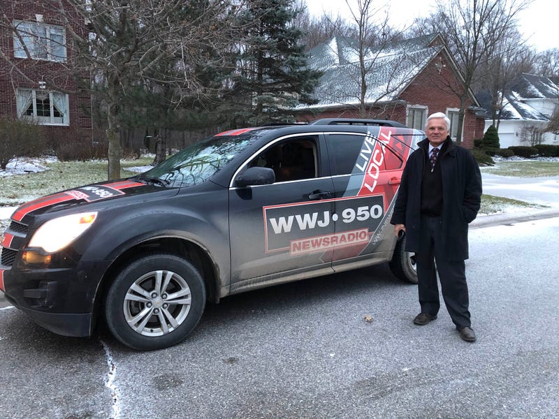 Mike Campbell is seen standing by his news car