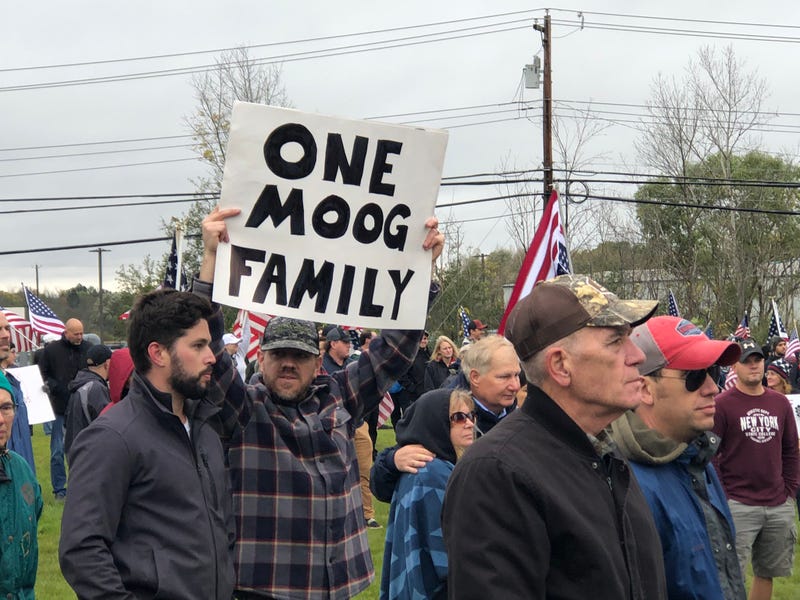 Erik Eimiller holds a sign after he joins approximately 200 employees who walked out of the job over the vaccine mandate. October 25, 2021
