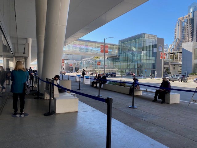 People wait in line to receive their COVID-19 vaccine at San Francisco's Moscone Center.