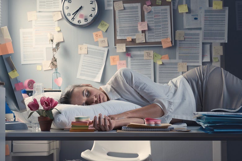 woman sleeping on her desk at work