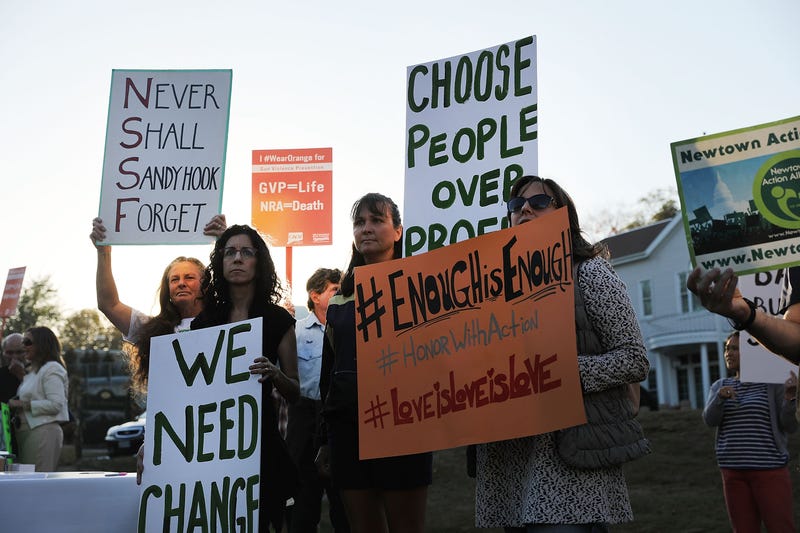  Dozens of people attend a vigil remembering the 58 people killed in the 2017 Las Vegas massacre and calling for action against guns on October 4, 2017 in Newtown, Connecticut. 